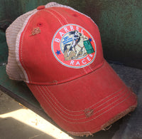 red cap with a barrel racer patch on it